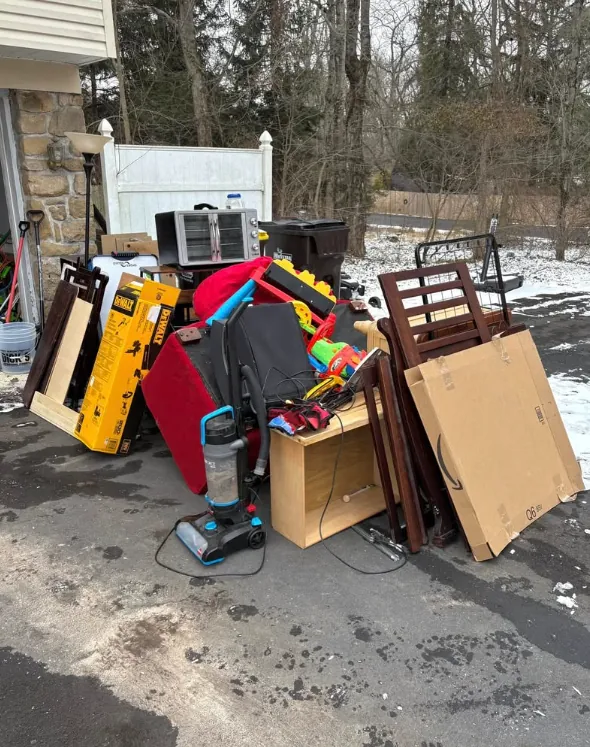 Furniture and mixed property contents staged on a driveway