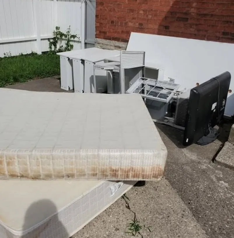 Mattress and other bulky household items staged outside