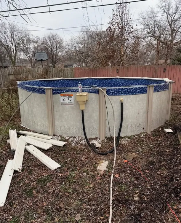 Above-ground pool and loose pool components in a yard